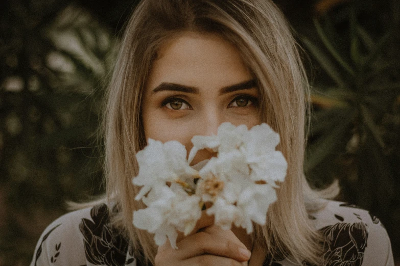 the young woman has a bunch of flowers in her hand