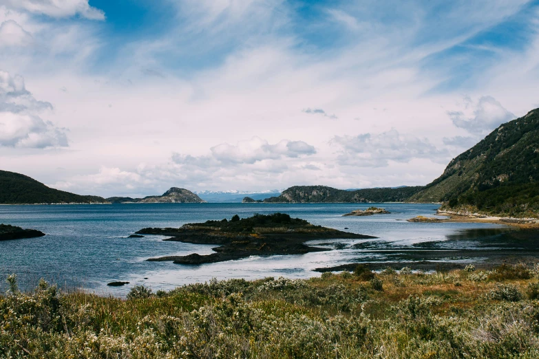 the ocean surrounded by land and large rocks