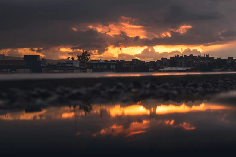 the sun is coming up behind clouds at sunset