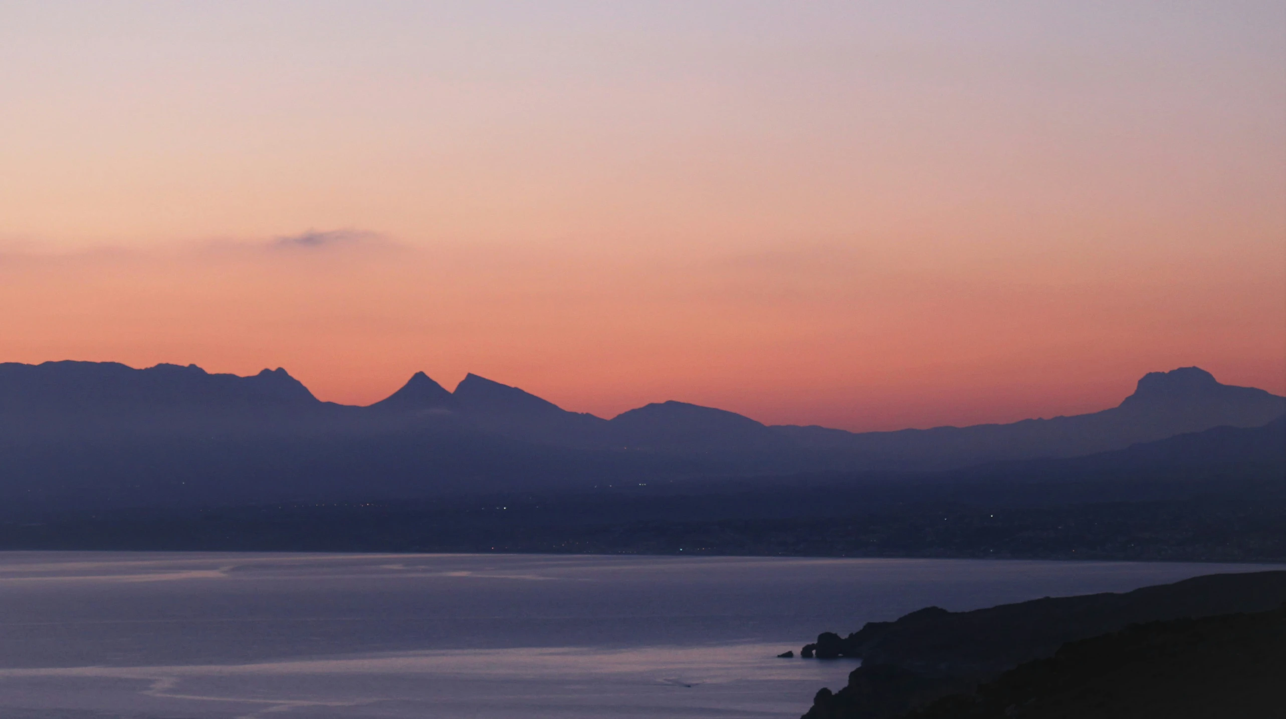 a view of a body of water surrounded by mountains