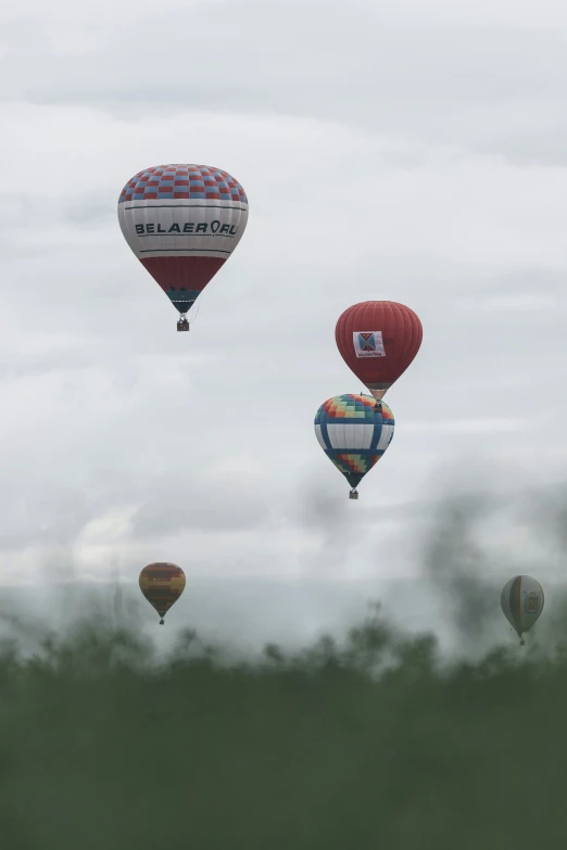 several multi - colored balloons in the sky