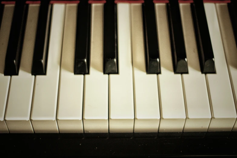 a close up view of a piano keyboard with the keys slightly turned off