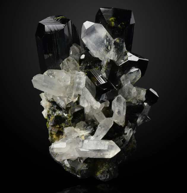 crystal cluster with green moss growing out of it