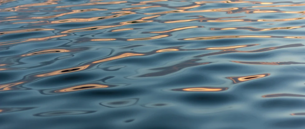 the reflection of some sky on some water