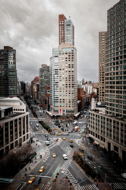 there is a busy city street with many people crossing the intersection