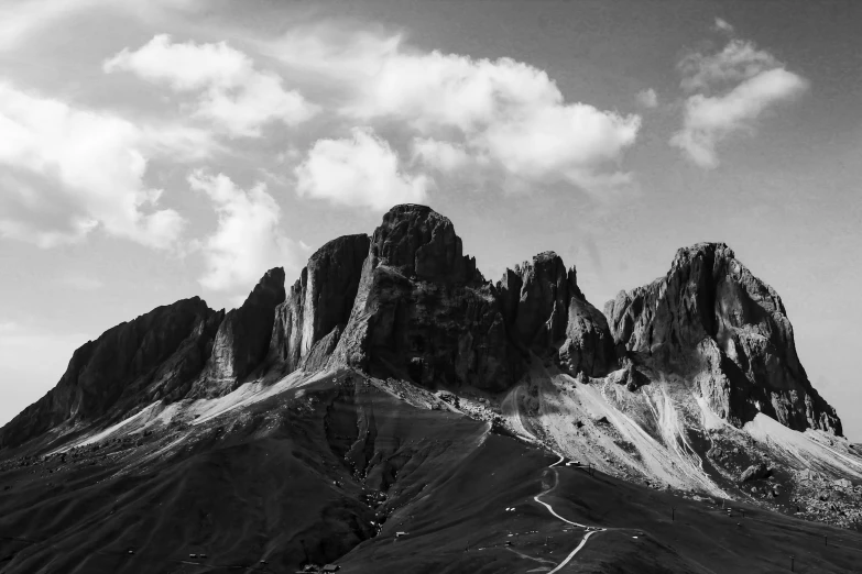 a very tall mountain with some clouds above