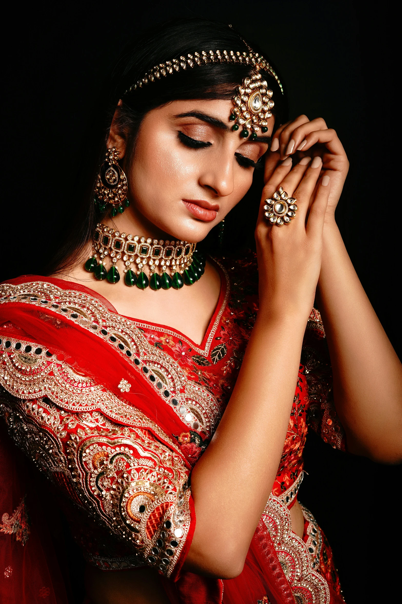 a woman in a red sari and jewellery