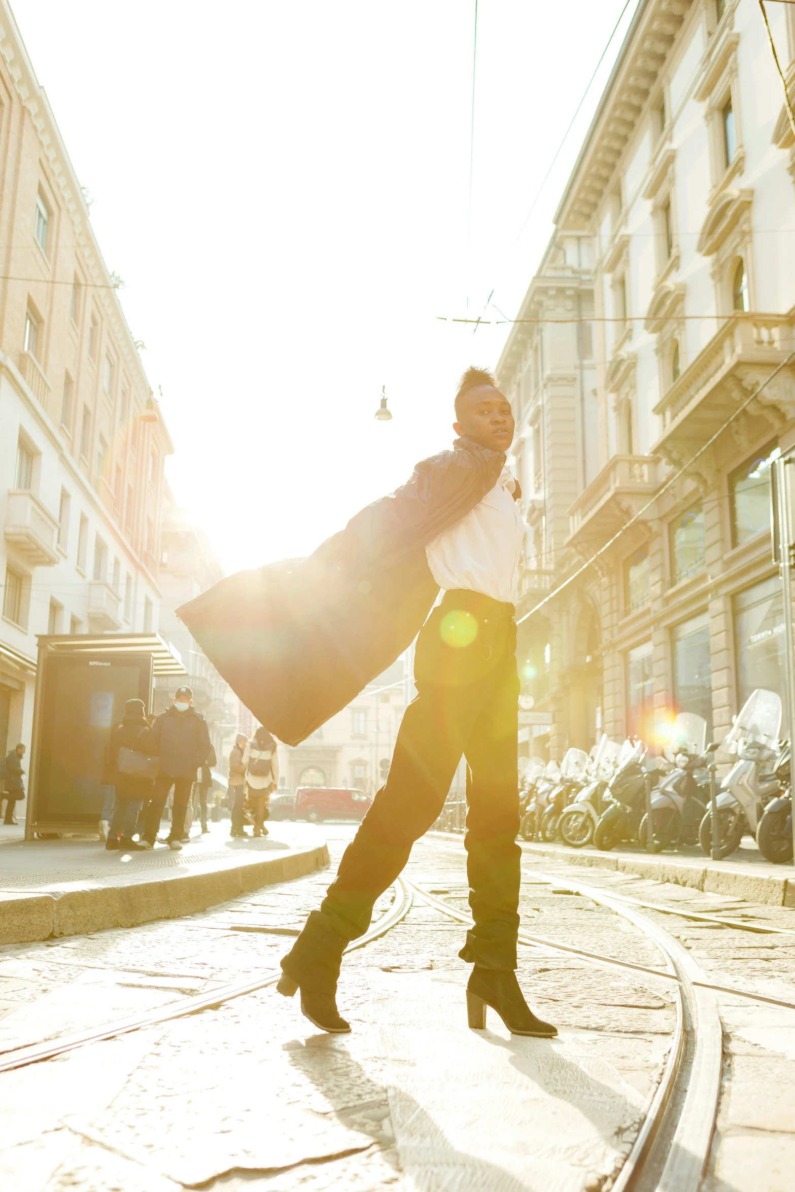 a woman standing on a street in a jacket