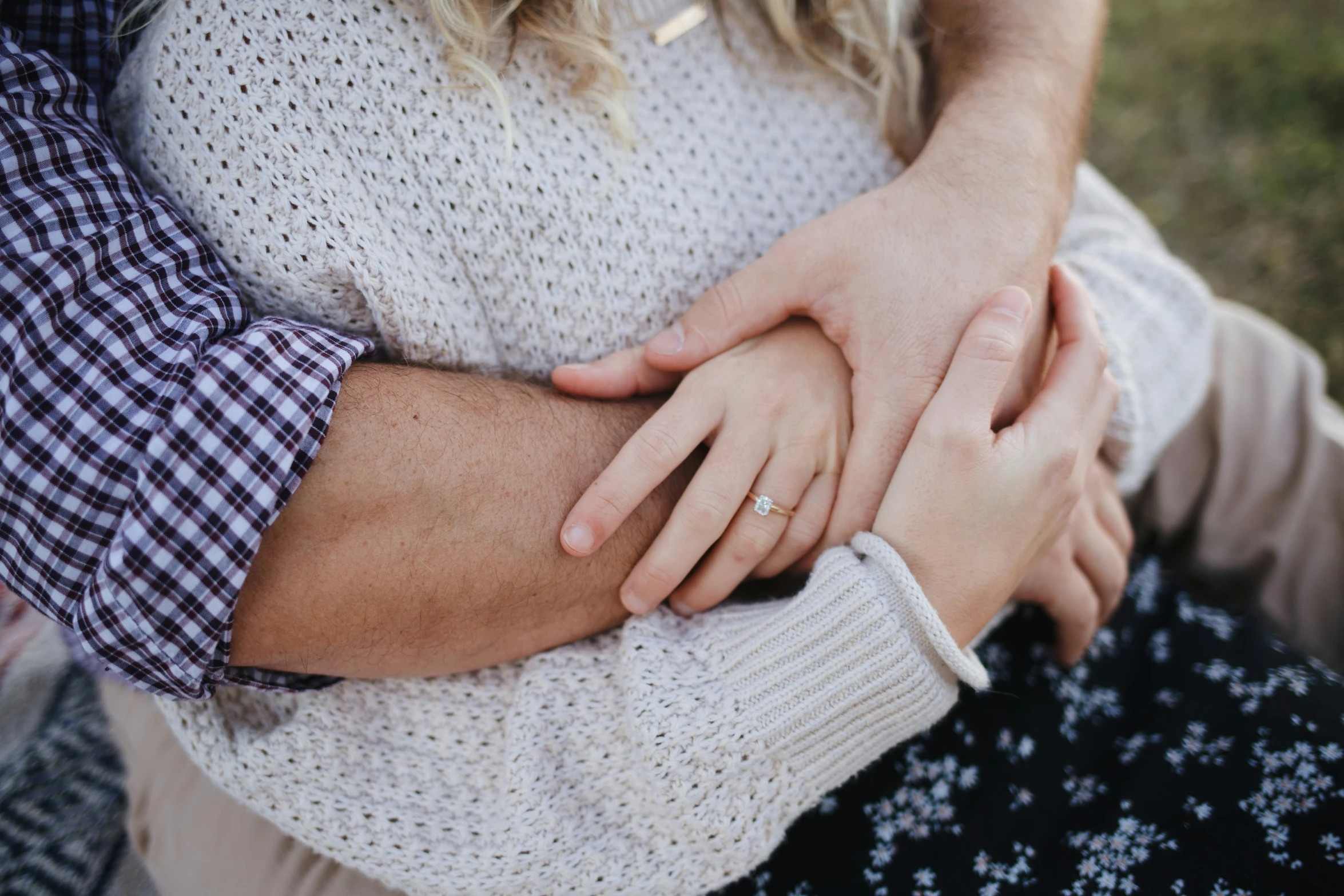 a couple holding hands with one another on their lap