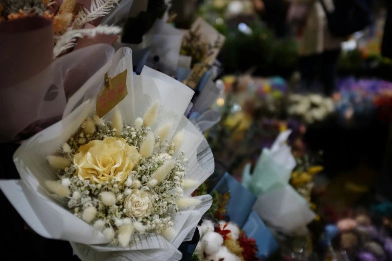 a bunch of flowers are on the shelf