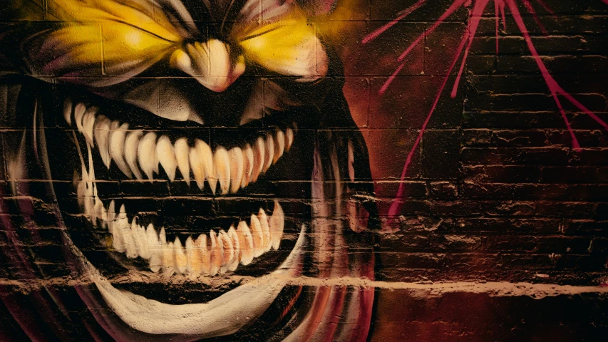 graffiti depicting an evil looking person with teeth and large fangs