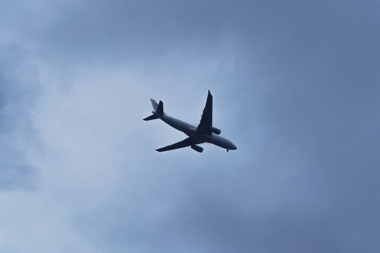 a large airplane flying through the sky with it's wings extended