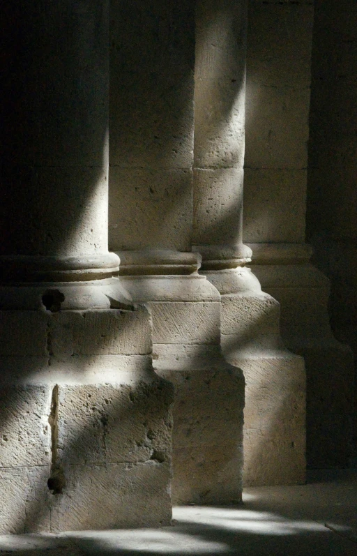 a stack of large stone columns in a building