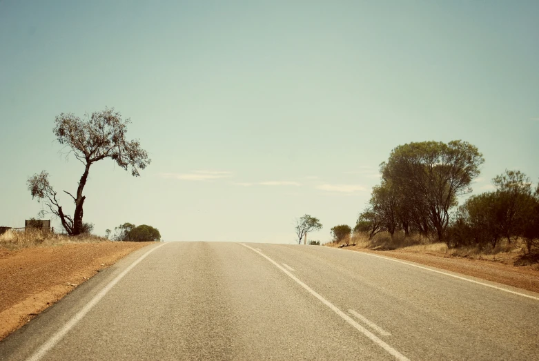 the view of a empty highway through the countryside