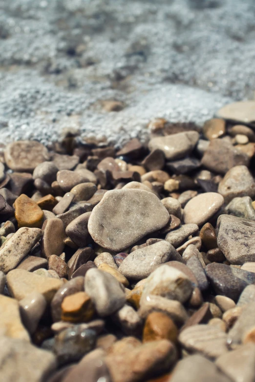 a close up of rocks with water in the background