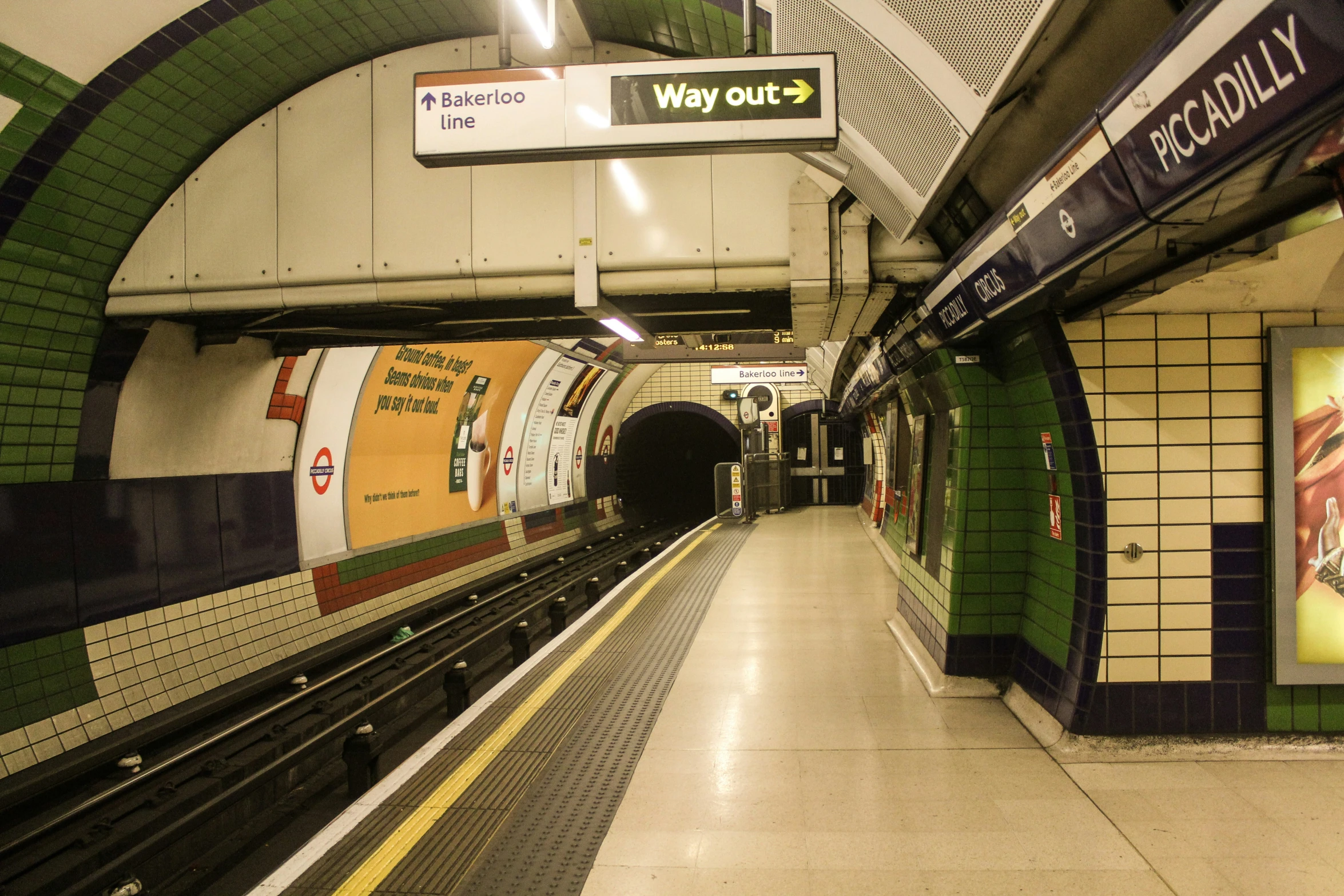 a subway train is approaching the platform with its light on