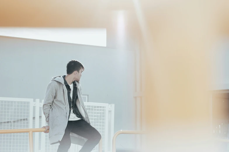 a man walking down stairs wearing a coat and tie