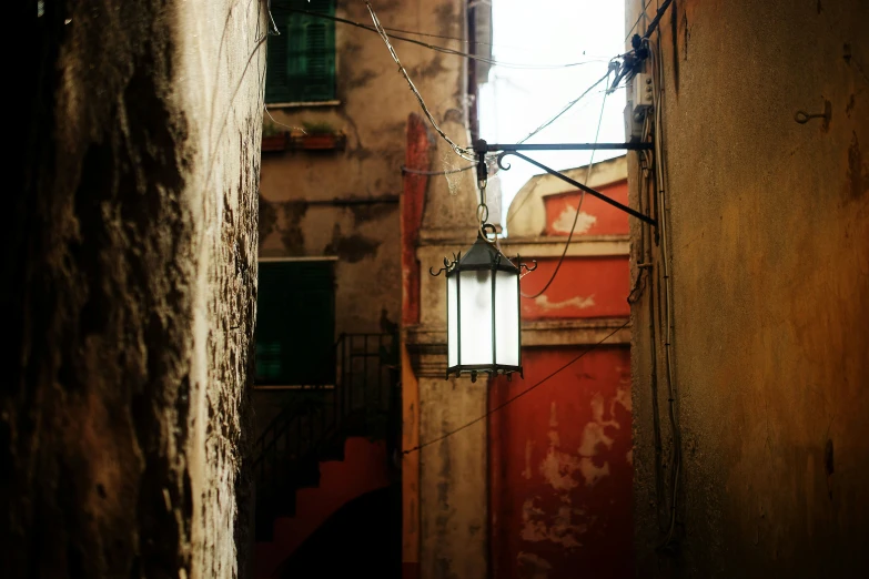 an alley way with a street lamp attached to it