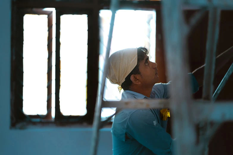 a man in a helmet looking out a window