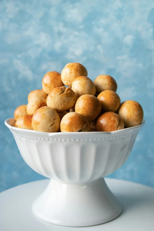 a bowl filled with some balls of doughnuts