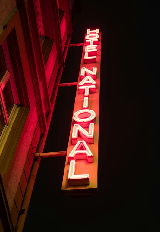 a neon sign that is advertising a bar on a building