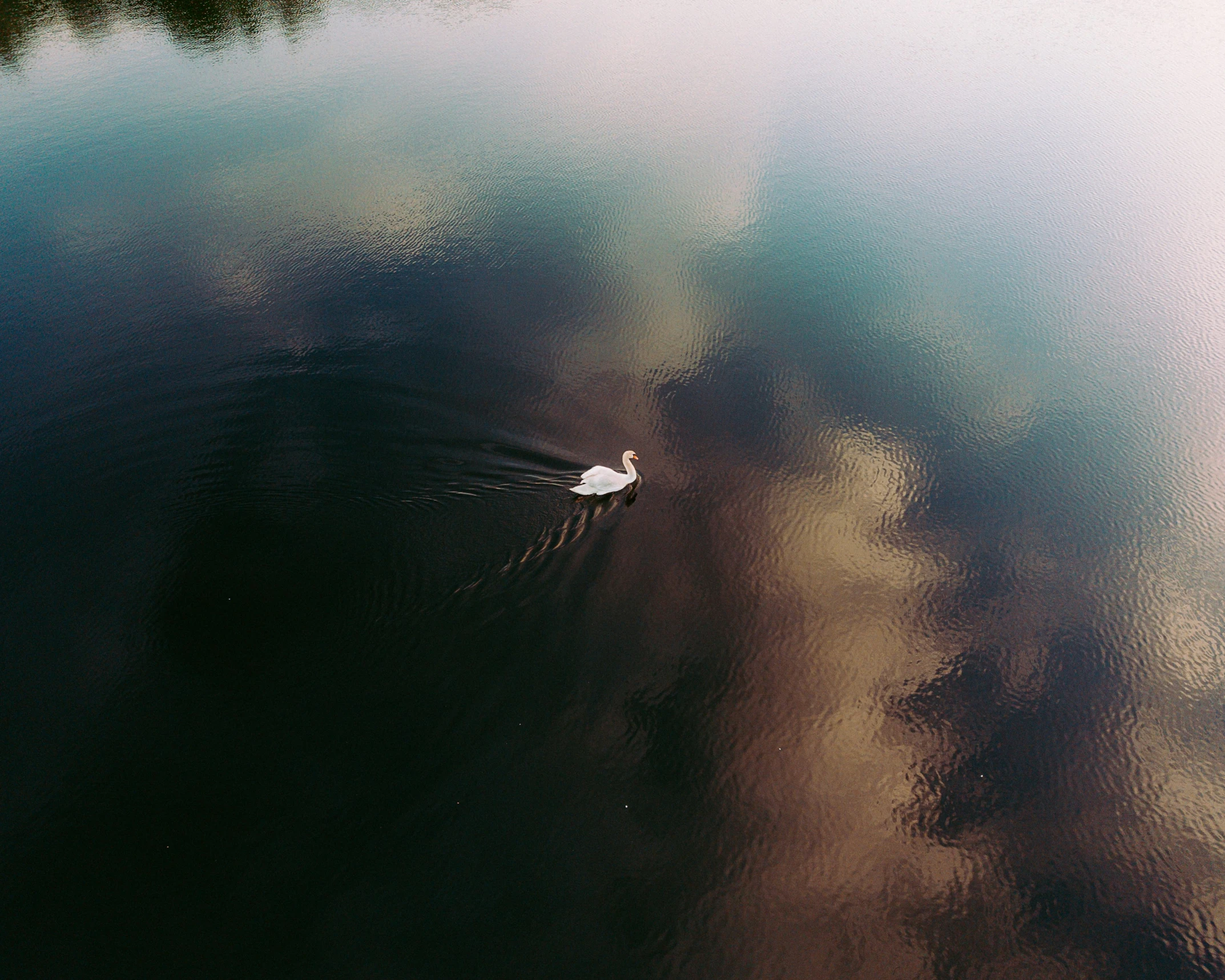 a lone boat floats on a calm lake