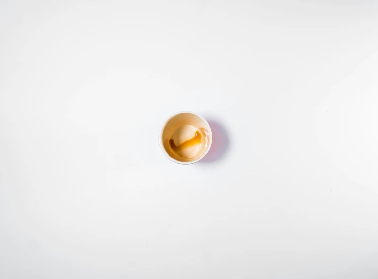 a small yellow object that is on a white wall