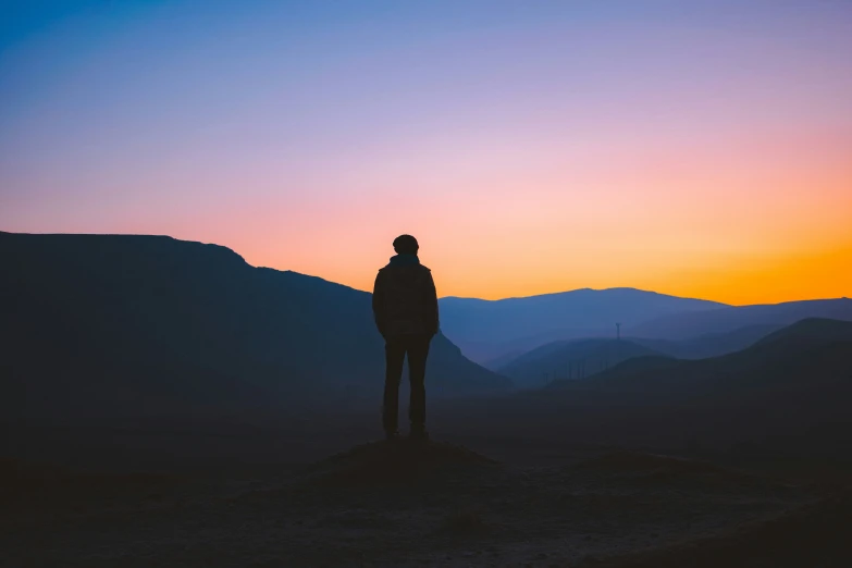 a person standing on top of a hill overlooking a valley