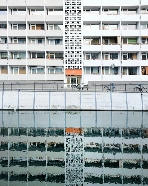 the building is reflected in the still water