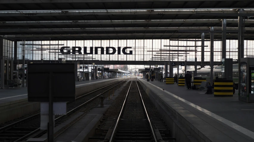 a train station with several tracks running parallel to each other