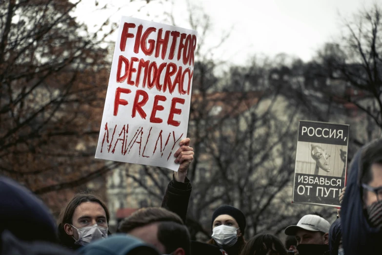 people holding up signs and wearing masks on march 3