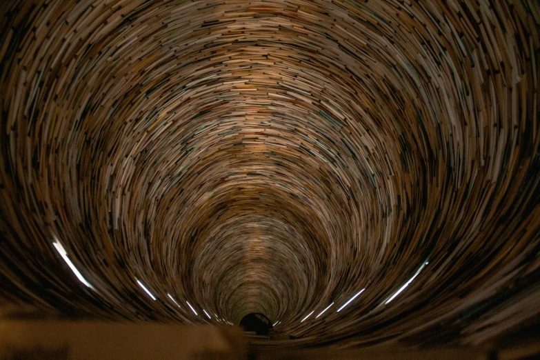 people are standing on the other side of a tunnel in the dark