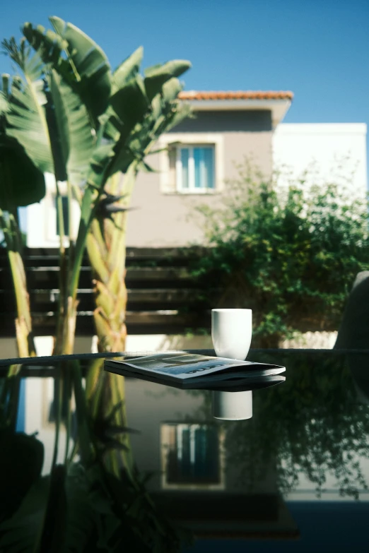 a table topped with a cup and a phone