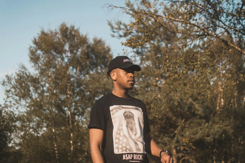 a man posing with his skateboard in hand