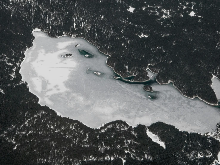 the aerial view of two boats in water and mountains