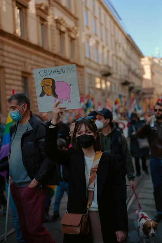 people are protesting with signs and wearing protective gear