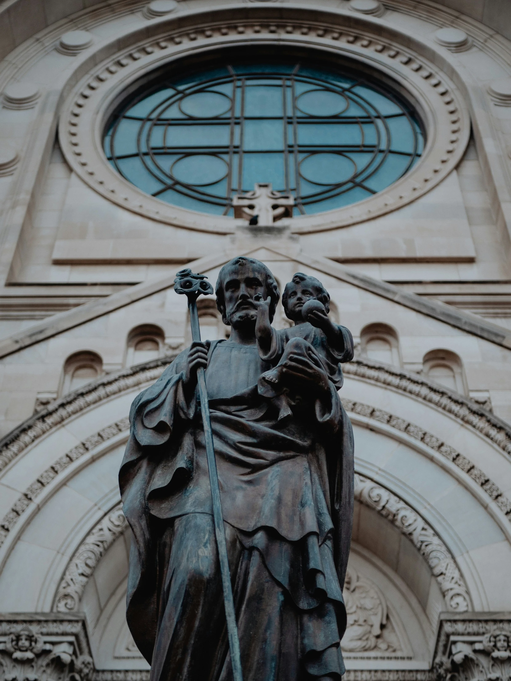 the statue of saint joseph in front of an ornate church