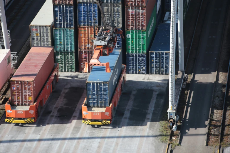 three stacks of shipping containers are parked next to each other