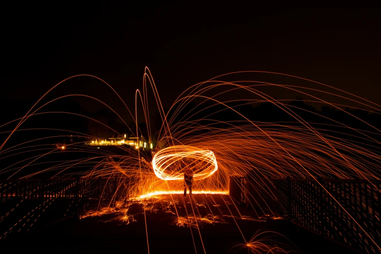 the man is standing near the fire and steel work