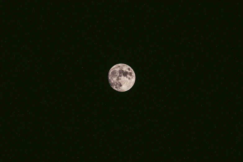 a half moon is seen over some stars