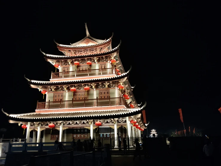 a tall building decorated with red lanterns and decorations