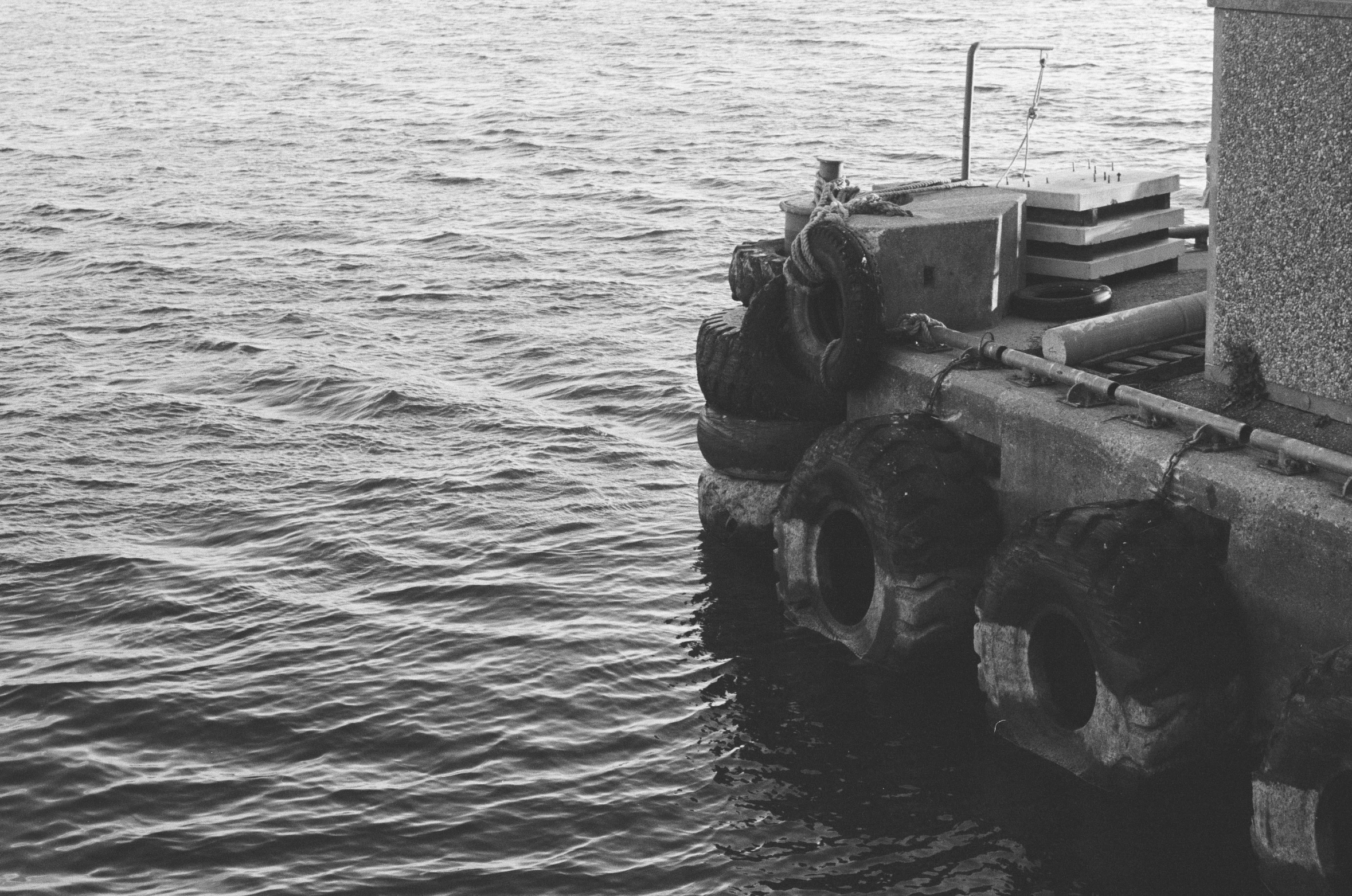 a boat is sitting by the side of the ocean