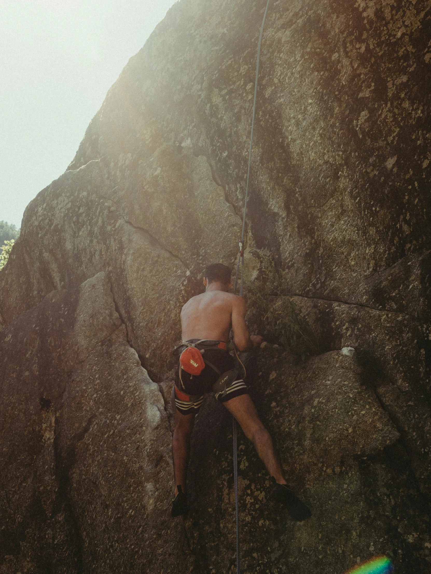 a man climbs up on a rock climbing