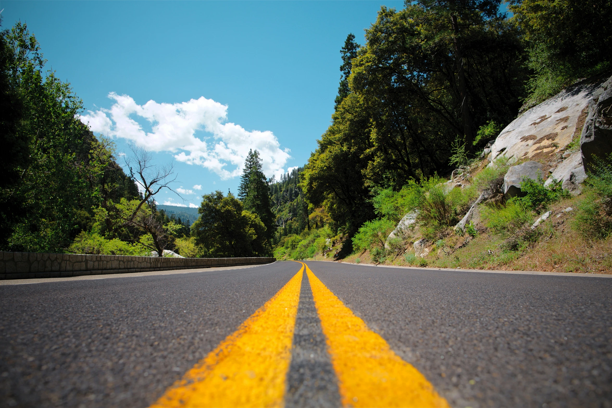 a yellow line on the road going up the hill