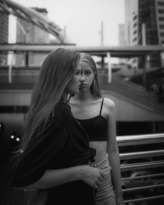 a  holding a cigarette standing next to an older woman