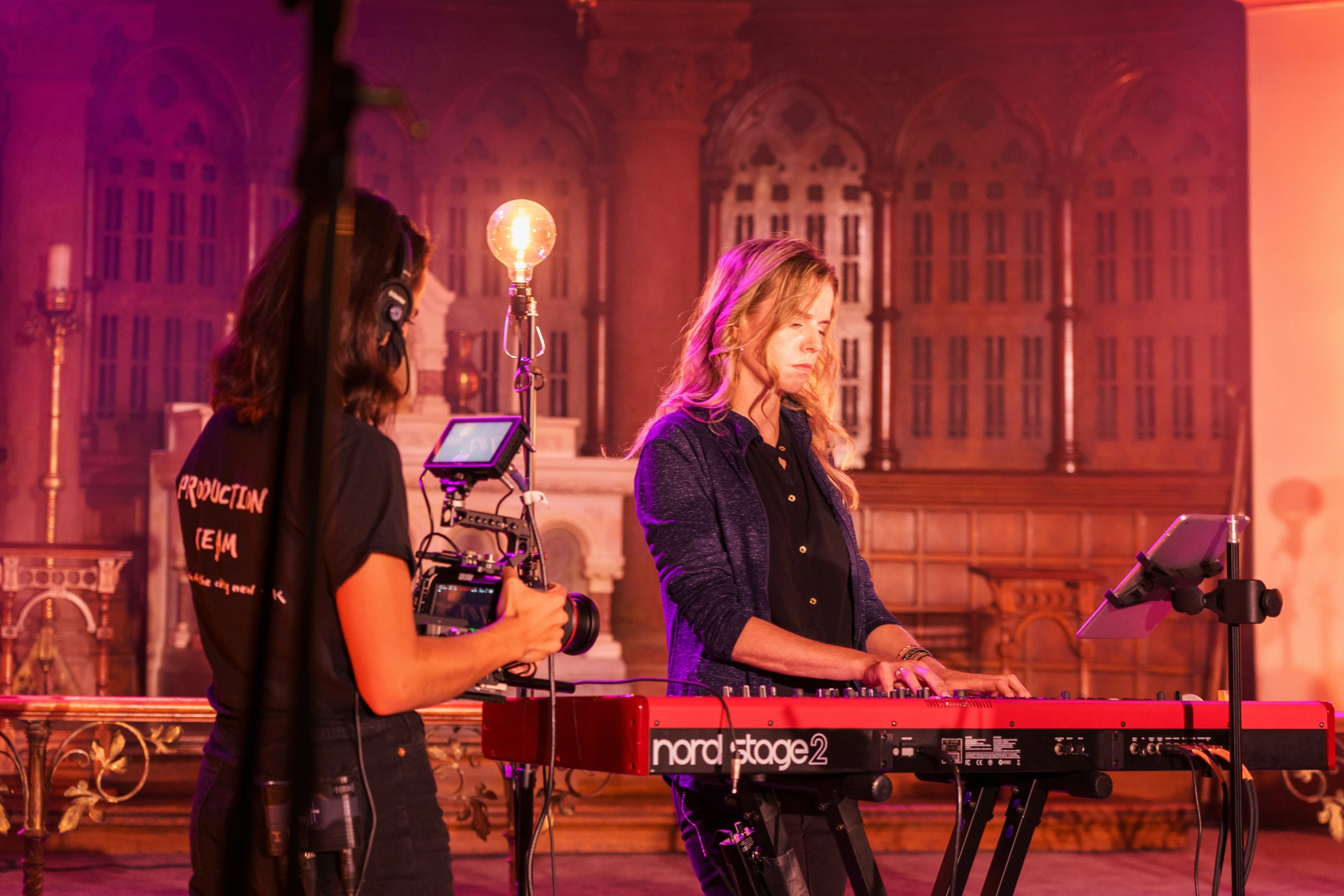 two people are standing next to each other playing keyboard