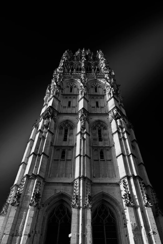 a black and white picture of a tall building with a clock