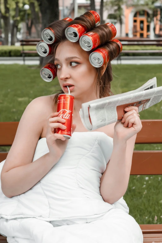 a woman with curl - out hair holding a soda