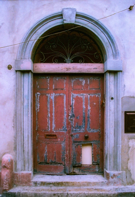 a red door with stone arch above it