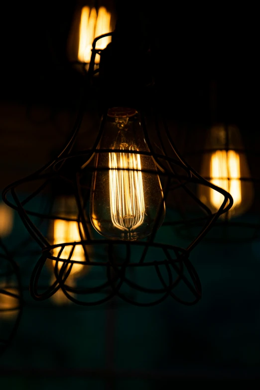 a lantern light hanging from the ceiling with bright lights in the dark